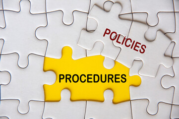 Top view of Policies and Procedures on white jigsaw puzzle. Policies and procedures concept
