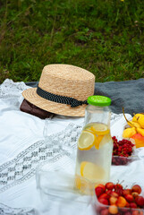 Summer picnic setting with straw hat and refreshing lemonade