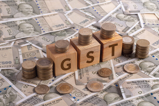 GST Word on Wooden Cubes with Indian Currency and Coins | Financial Investment Concept