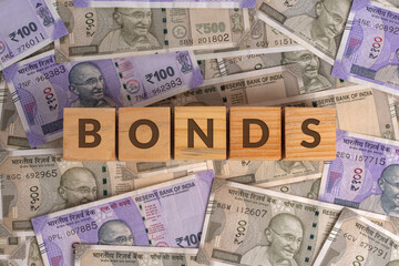 Bonds Word on Wooden Cubes with Indian Currency Background | Financial Growth Concept