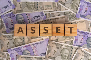 Asset Word on Wooden Cubes with Indian Currency Background | Financial Growth Concept