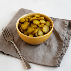Organic Green Pickle Chips in a Bowl, side view.