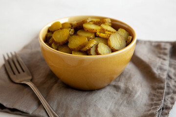 Organic Green Pickle Chips in a Bowl, side view. Close-up.