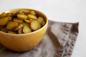 Organic Green Pickle Chips in a Bowl, side view. Copy space.