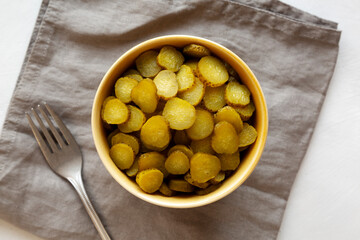 Organic Green Pickle Chips in a Bowl, top view. Flat lay, overhead, from above.