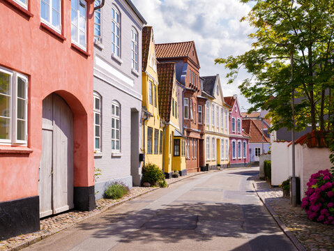 Streetscape with pastel-colored townhouses in S&oslash;nderborg old town, Als Island, Denmark