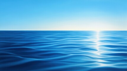 Obraz premium A serene ocean view, showcasing the gentle waves reflecting the sunlight. The vibrant blue water meets the clear sky, creating a tranquil atmosphere perfect for relaxation.
