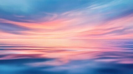 Obraz premium A serene ocean scene at sunset, showcasing vibrant hues of pink and blue in the water and sky. This tranquil image captures the beauty of nature and evokes a sense of peace.