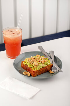 Avocado toast with seed and cashew nuts on breakfast table