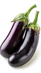 Two isolated eggplants rest against a plain background, showcasing their deep purple hue and shiny finish. These fresh vegetables promise to enhance a variety of delicious dishes