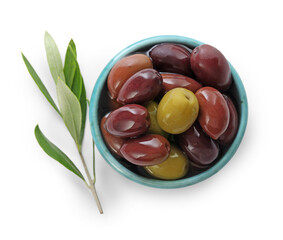 Delicious marinated olives in bowl and leaves isolated on white, top view