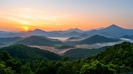 Fototapeta premium Golden Sunrise Over Misty Mountain Valley