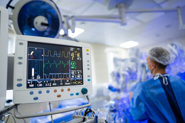 Staff track vitals in surgery. Medical personnel use advanced equipment to monitor patient health in a surgical setting, ensuring safety and care.
