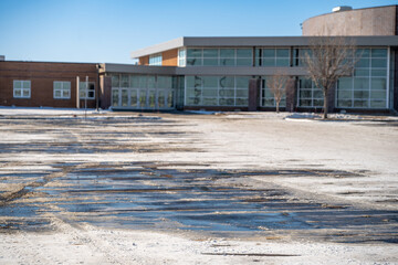 Snow covered parking lot with the lines covered in some locations.
