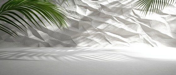 A serene beach scene with a white rock wall, palm tree, and sandy beach.