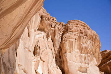 Fototapeta premium Cliff in Aqaba desert, Egypt, Sinai Peninsula, abstract. Yellow sand rock texture. Sandstone Cliffs view.