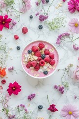 Naklejka premium Pink Smoothie Bowl with Raspberries, Blueberries, and Edible Flowers, Healthy Breakfast Concept