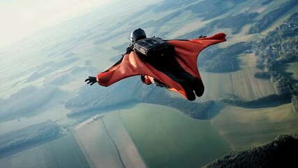Wingsuit pilot performing daring aerial acrobatics, gliding with precision over verdant rural landscape, showcasing extreme sport skill and freedom