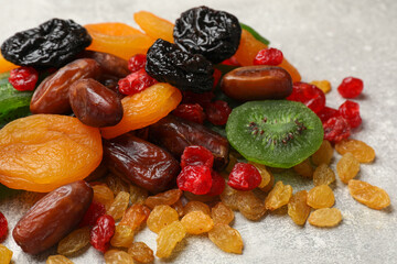 Mix of different dried fruits on light grey table, closeup