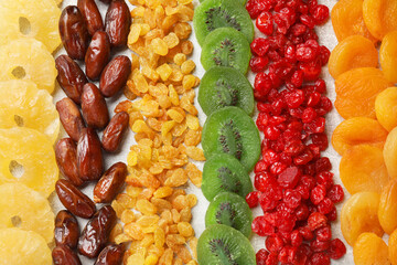 Different dried fruits on light table, flat lay
