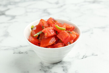Delicious salsa on white marble table, closeup