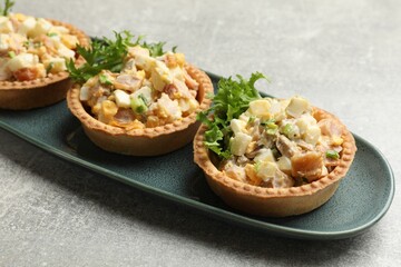 Tartlets with delicious filling on grey table, closeup