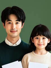 Obraz premium Expert Home Loan Advice for Secure Home Ownership. Father and daughter posing together, smiling against a green background.