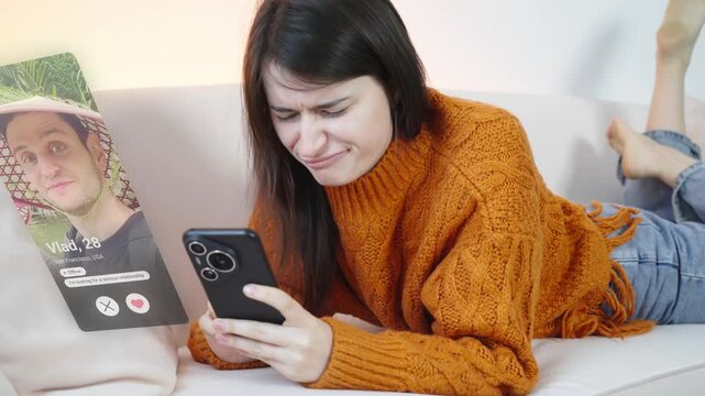 Visual concept of the young woman using dating app on smartphone and gets a match. Attractive brunette woman in home interior looking for a man in a dating app