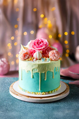 Pastel blue birthday cake with roses decoration