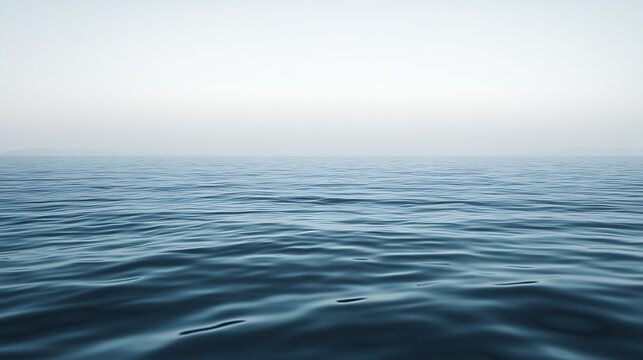 Calm Ocean Waves Under a Misty Sky
