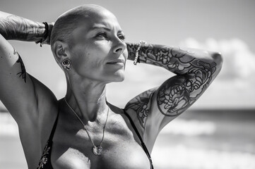 older woman with bald head and tattoos in nature