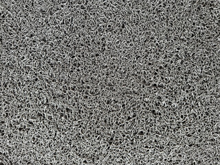 Close up of rubber floor mat grey tufts in random pattern. Seamless carpet rug or mat background texture in grey color. Suitable for front door.