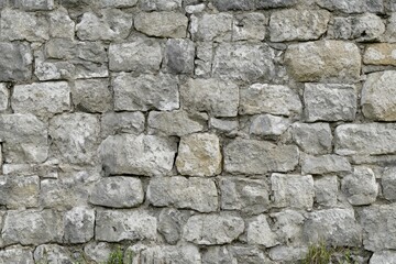 Fototapeta premium Rough stone wall with varied texture and color. Neural network AI generated