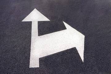 road marking painted on the asphalt with arrow in a straight line and right turn