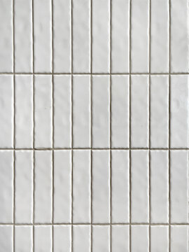 Bright white subway tiles seamless background texture. Subway tiles are often used in bathrooms or commercial places for its unique vertical brick style pattern