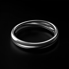 Elegant silver ring on black background reflects minimalist design aesthetics