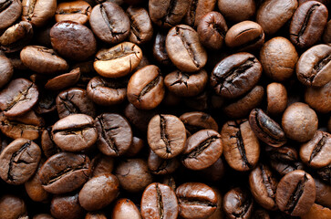 Roasted coffee background, texture, top view. Top view of coffee beans, background, texture. Coffee beans as a background for packaging use.