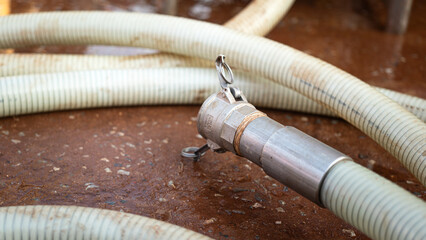 High pressure water jetting hose with metal nozzle head. Industrial equipment object, close-up.