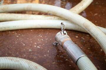 High pressure water jetting hose with metal nozzle head. Industrial equipment object, close-up.