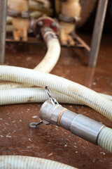 High pressure water jetting hose with metal nozzle head. Industrial equipment object, close-up.