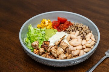 Fiesta bowl, Mexican food dish bowl with chicken, rice, corn and vegetables. Taco or burrito bowl. 