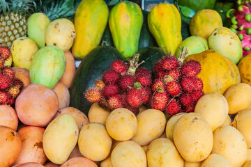 Various kinds of tropical fruit at the traditional market fruit seller's stall