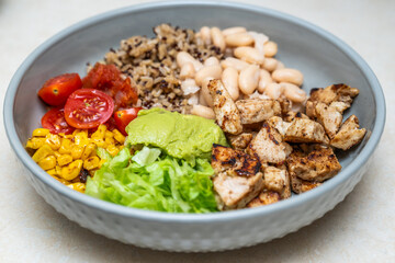 Fiesta bowl, Mexican food dish bowl with chicken, rice, corn and vegetables. Taco or burrito bowl. 