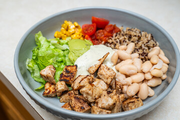 Fiesta bowl, Mexican food dish bowl with chicken, rice, corn and vegetables. Taco or burrito bowl. 