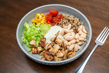 Fiesta bowl, Mexican food dish bowl with chicken, rice, corn and vegetables. Taco or burrito bowl. 