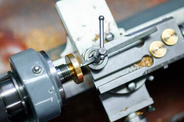 Precision shaping of metal on a small-sized lathe in a workshop environment