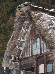 Traditional Gassho-Zukuri House with Thatched Roof in Shirakawa-go, Japan, Partially Covered in Snow