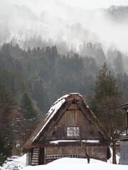 Traditional Gassho-Zukuri House with Thatched Roof in Shirakawa-go, Japan, Partially Covered in Snow