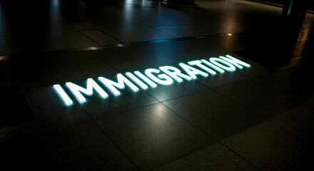 Bright signage for immigration services illuminates a modern airport terminal at night, guiding travelers through the space