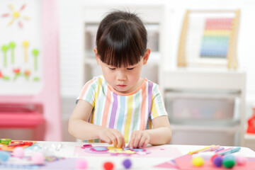 A young girl was creating a craft at home